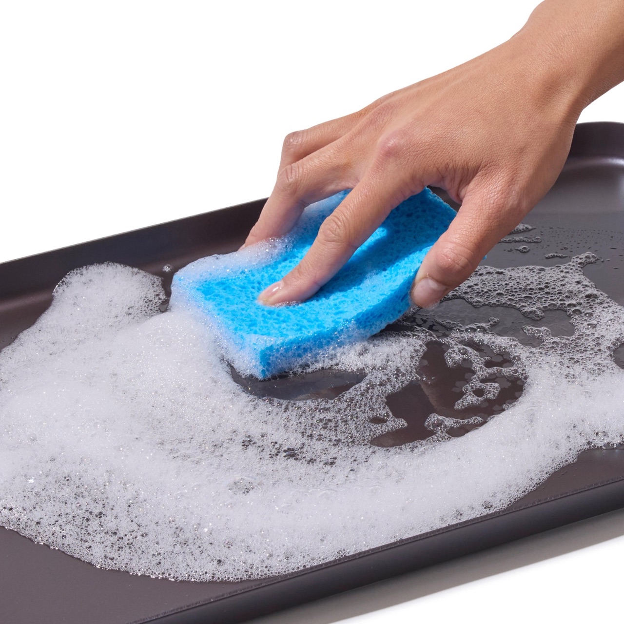 Washing the OXO Outdoor double burner griddle with a soft sponge