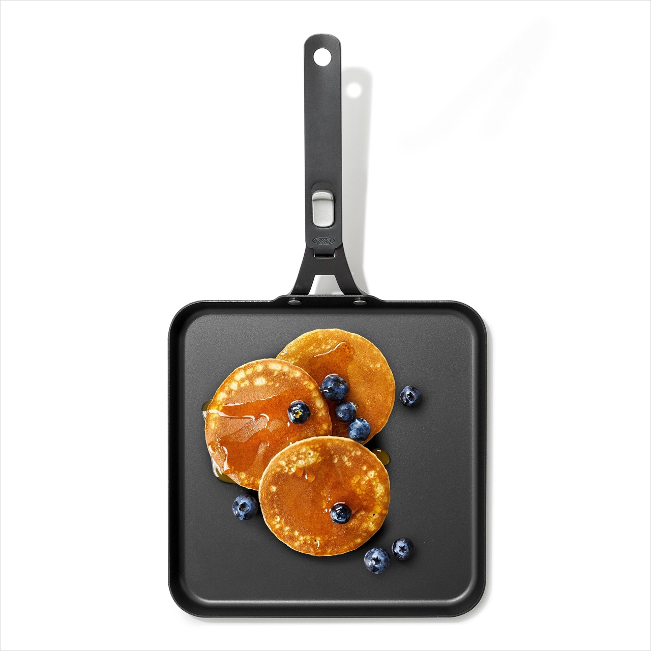 Pancakes and blueberries cooking on the OXO Outdoor carbon steel griddle pan